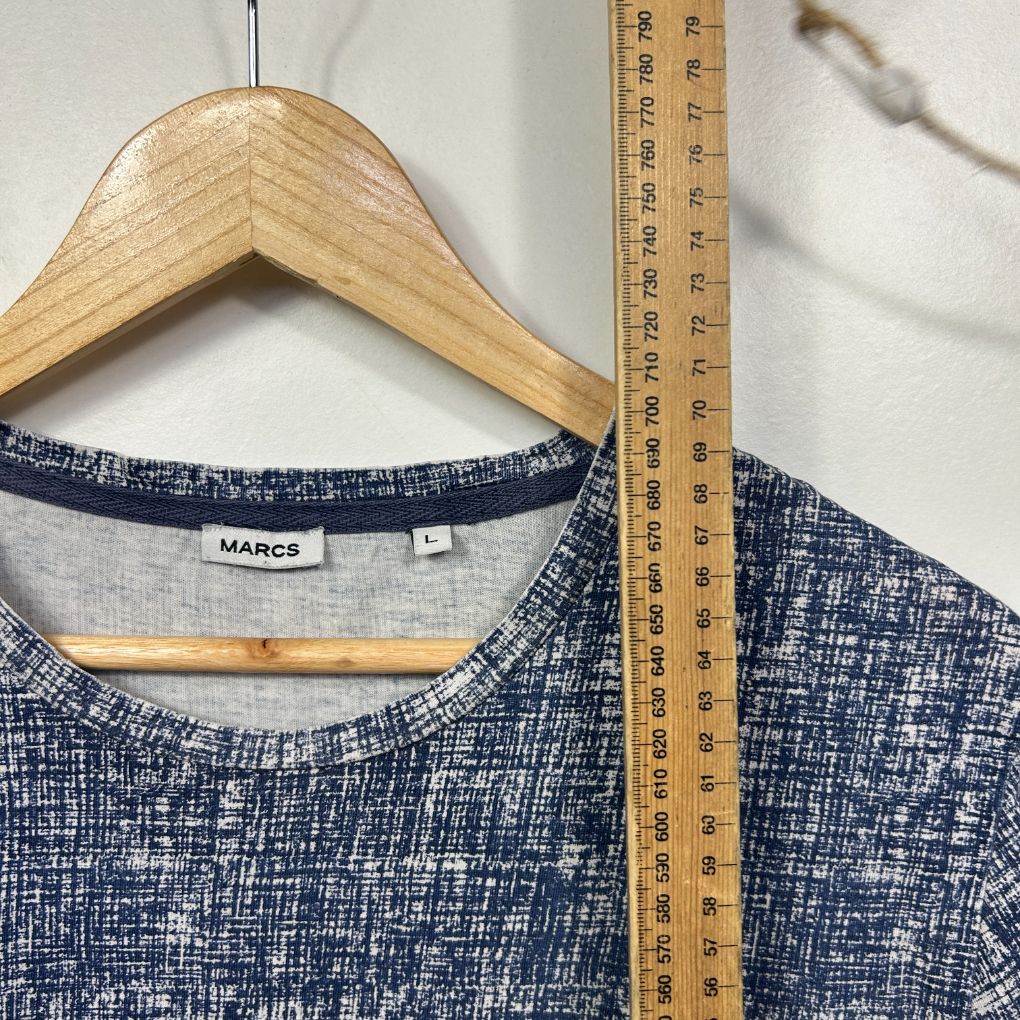 Navy textured jumper front view with wooden hanger and measuring tape