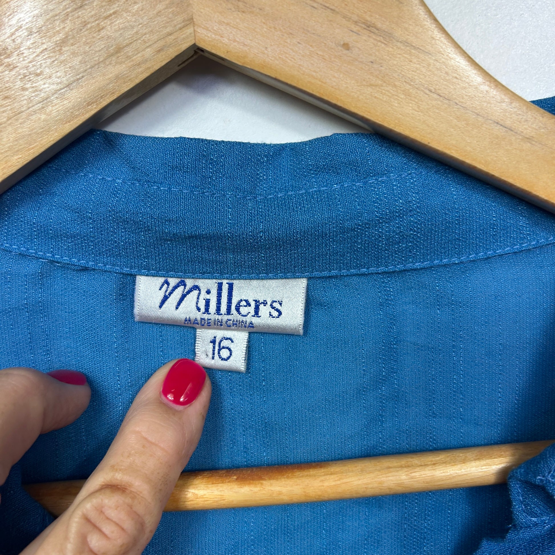 Blue knit top label detail view