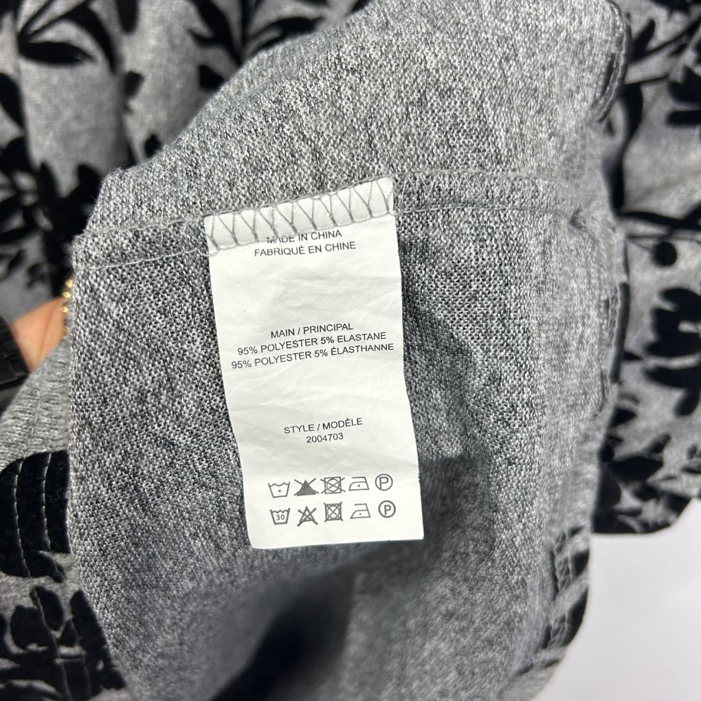 Grey knit jumper label detail view