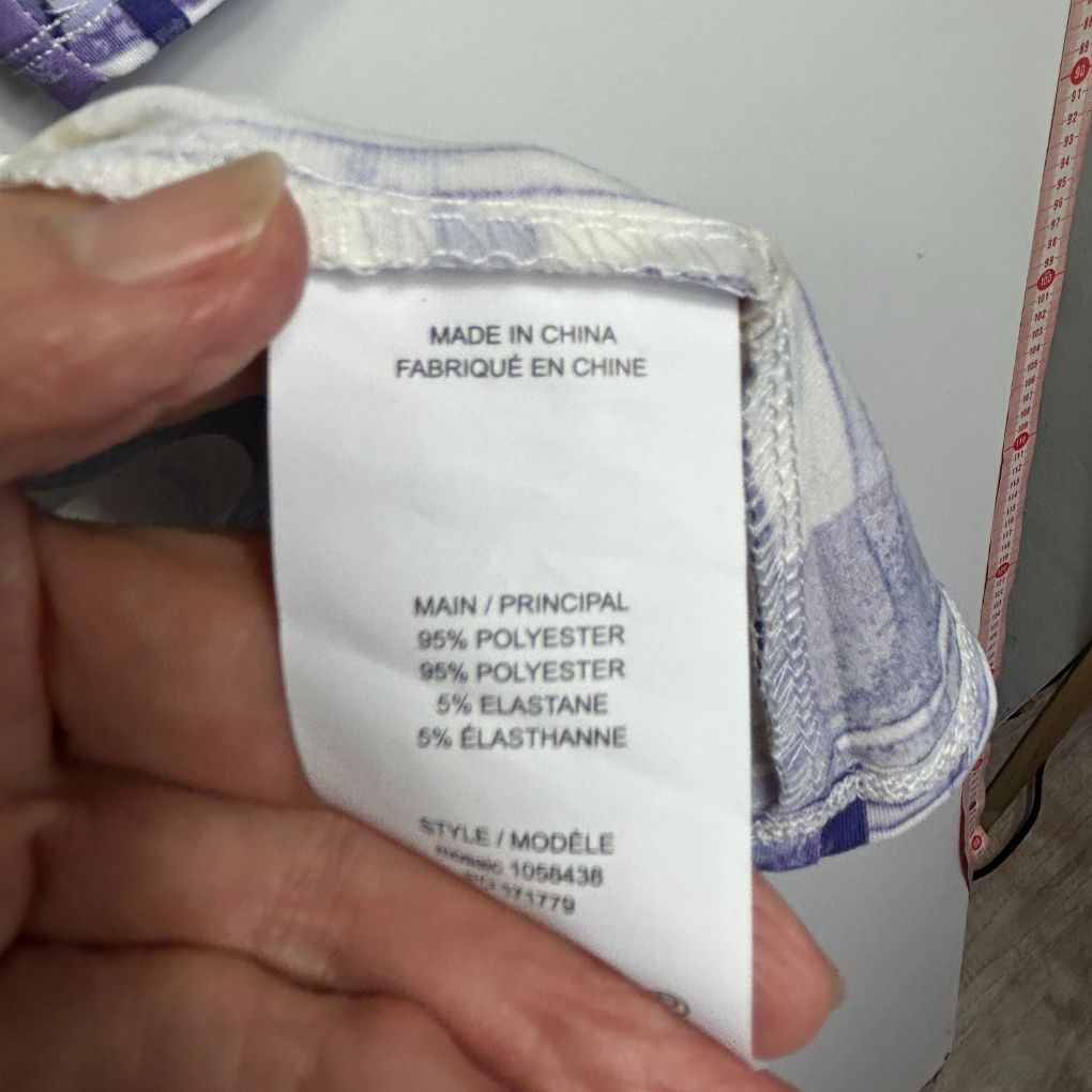 White garment label detail view showing fabric composition