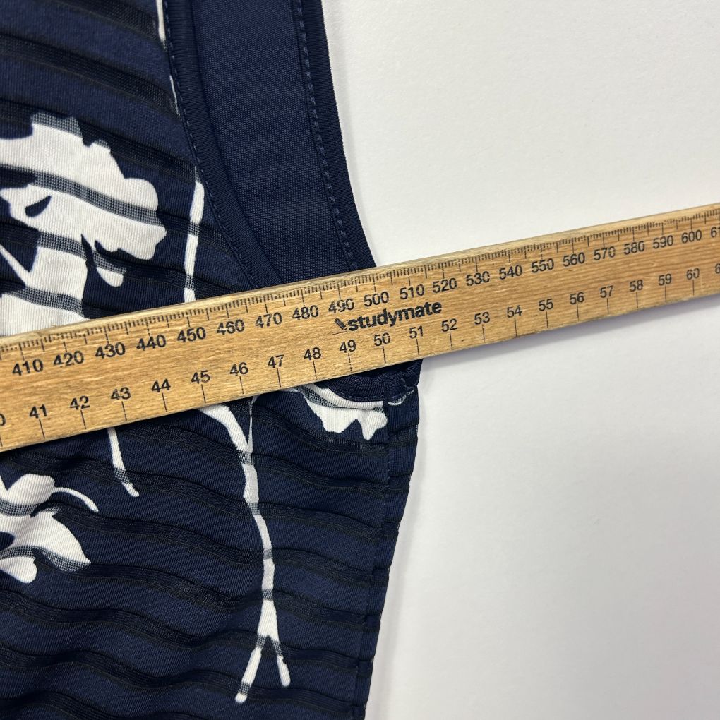 Navy blue shorts with white graphic print detail view with measuring tape