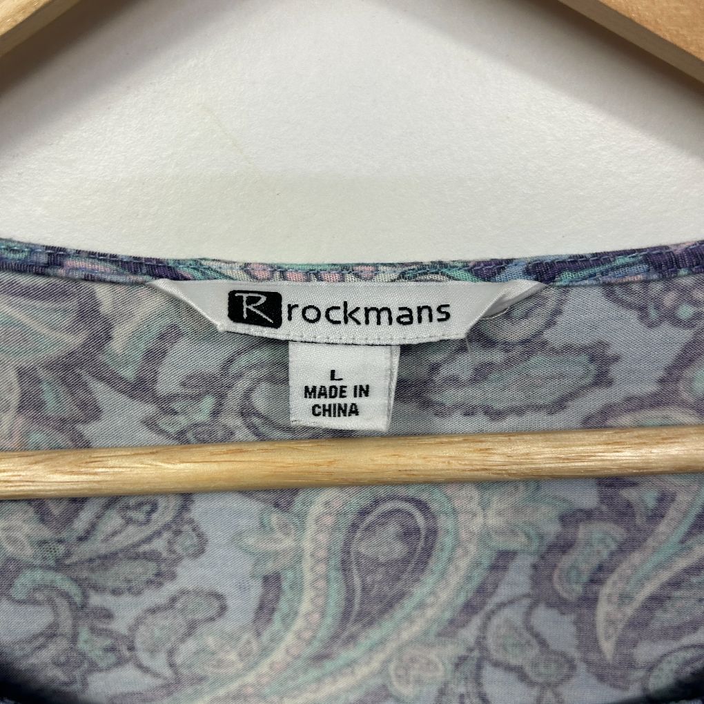 Blue paisley patterned garment label detail view
