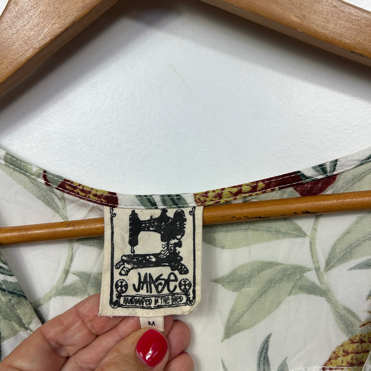 Cream fabric with floral print and sewing machine label detail view