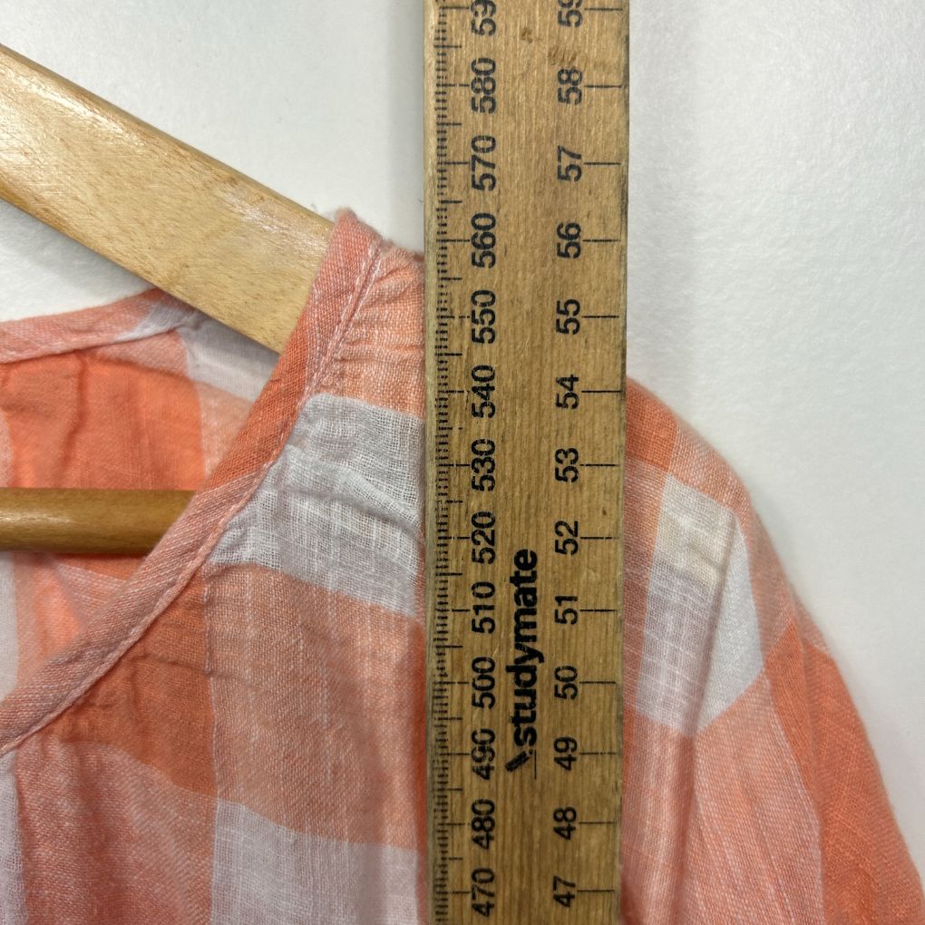 Orange and white checked shirt detail view with measuring ruler