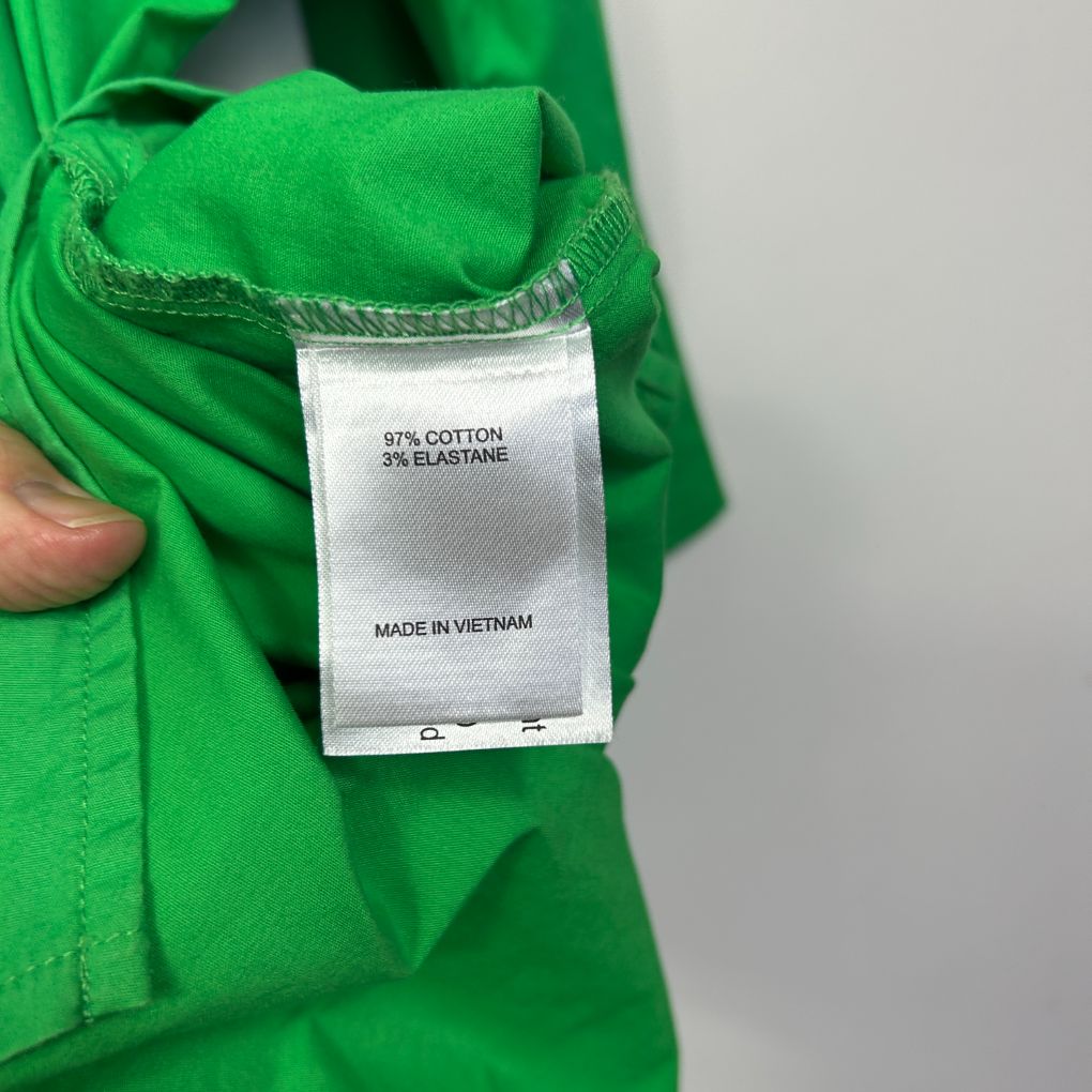 Green garment label detail view