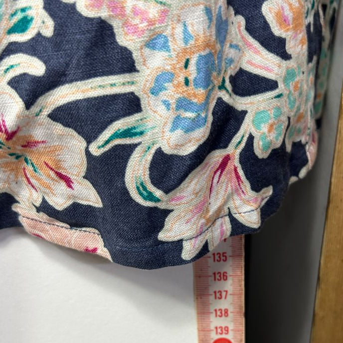 Navy floral blouse detail view with measuring tape