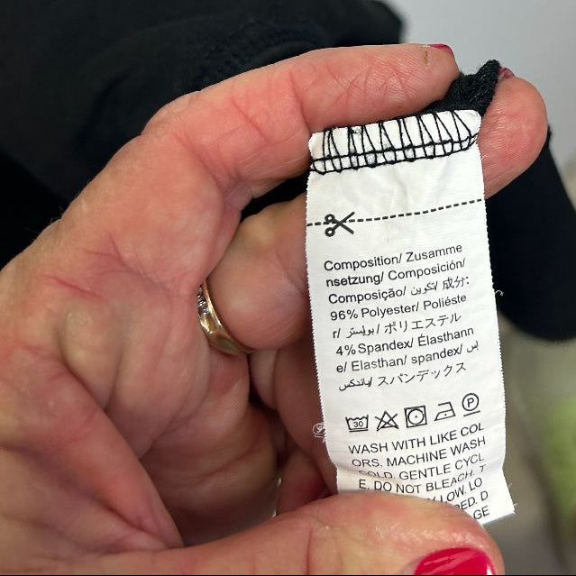 Black garment care label detail view