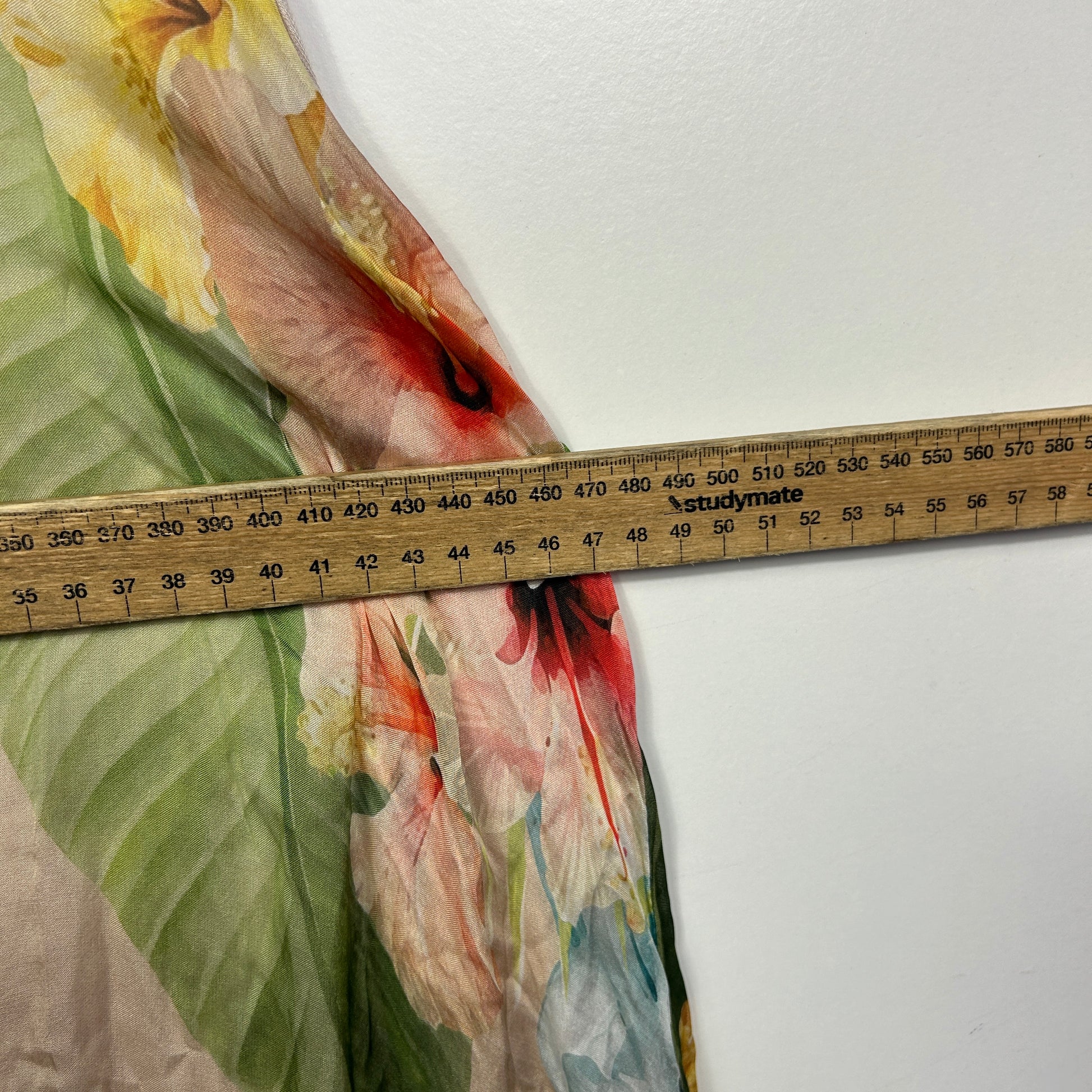 Multicolored fabric detail view with measuring tape