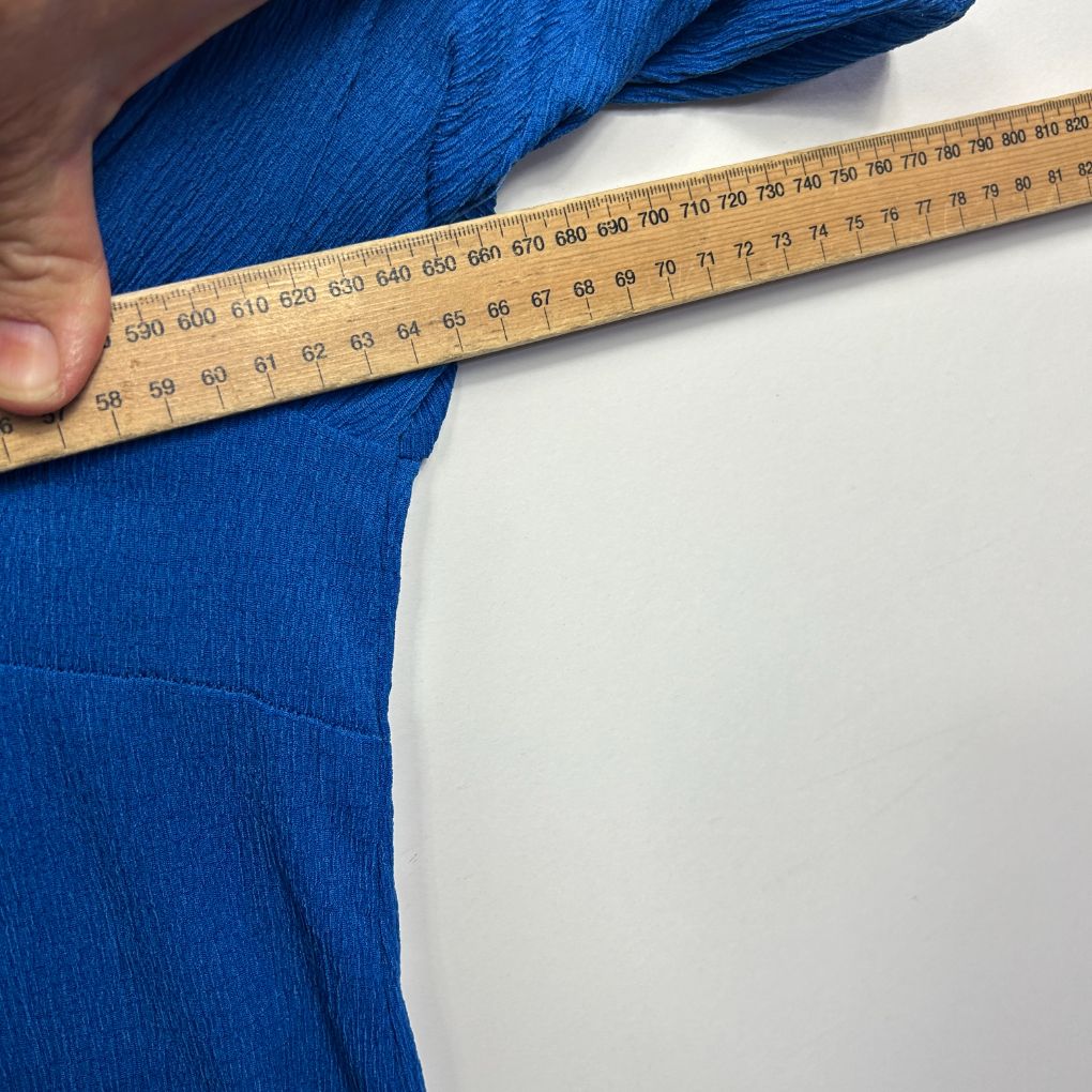 Blue fabric measured with tape measure detail view