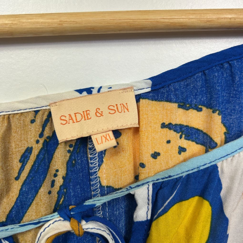Blue and gold graphic print scarf detail view with Sadie and Sun label