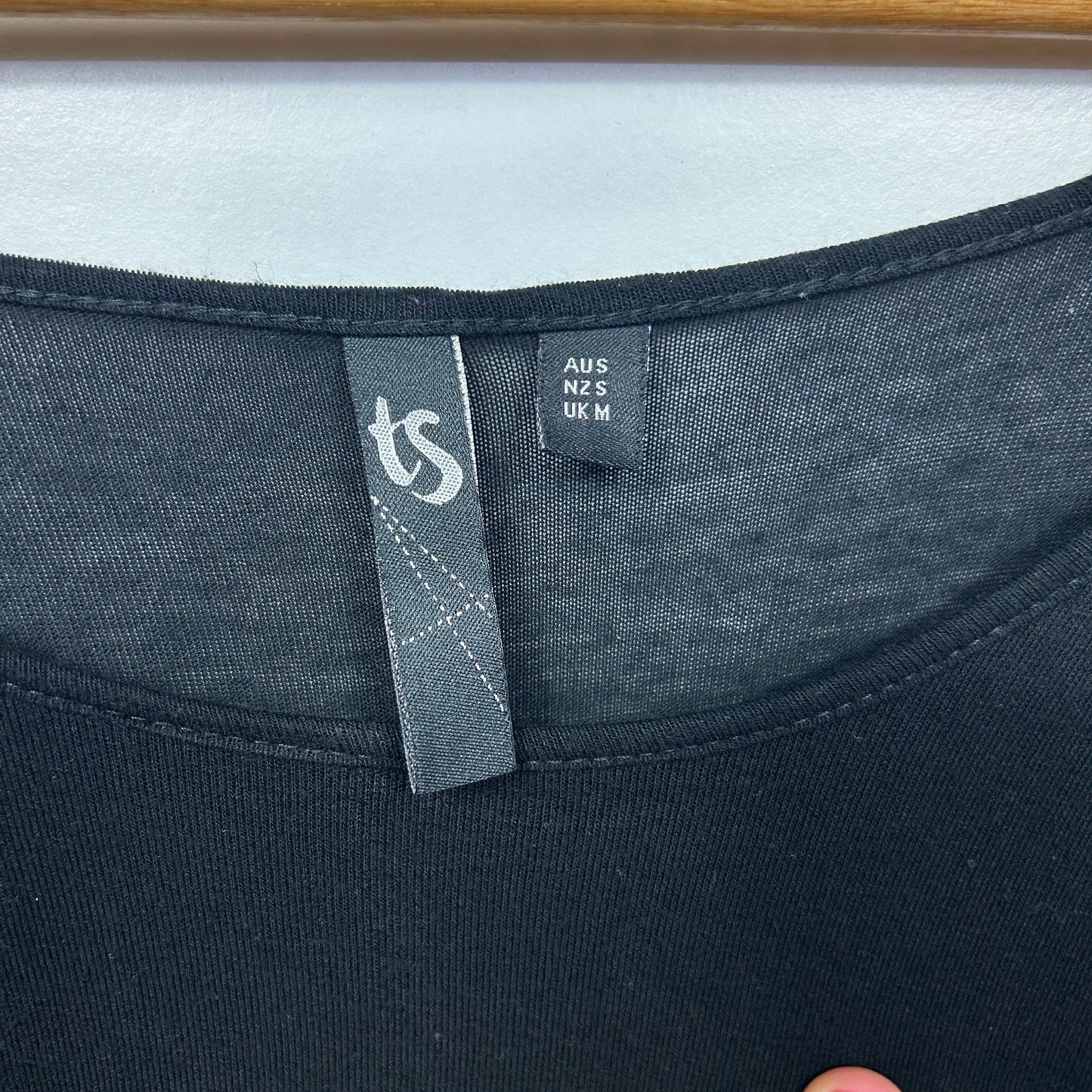 Black t-shirt label detail view