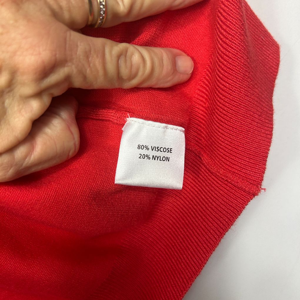 Red knit garment label detail view