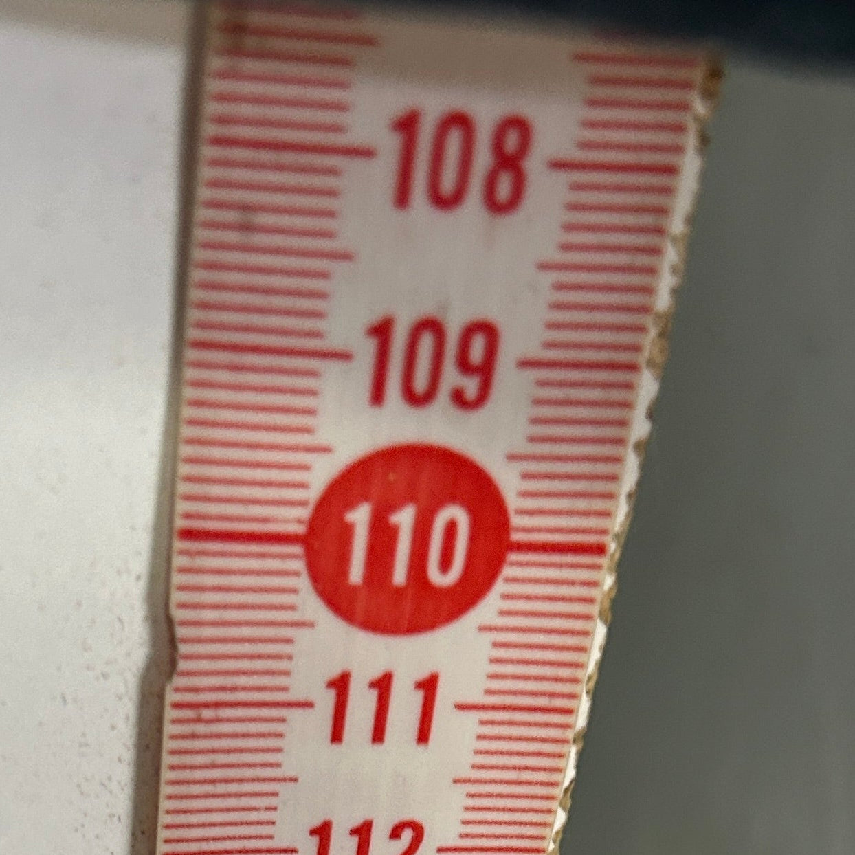 Measuring tape detail showing size markings 108 to 119