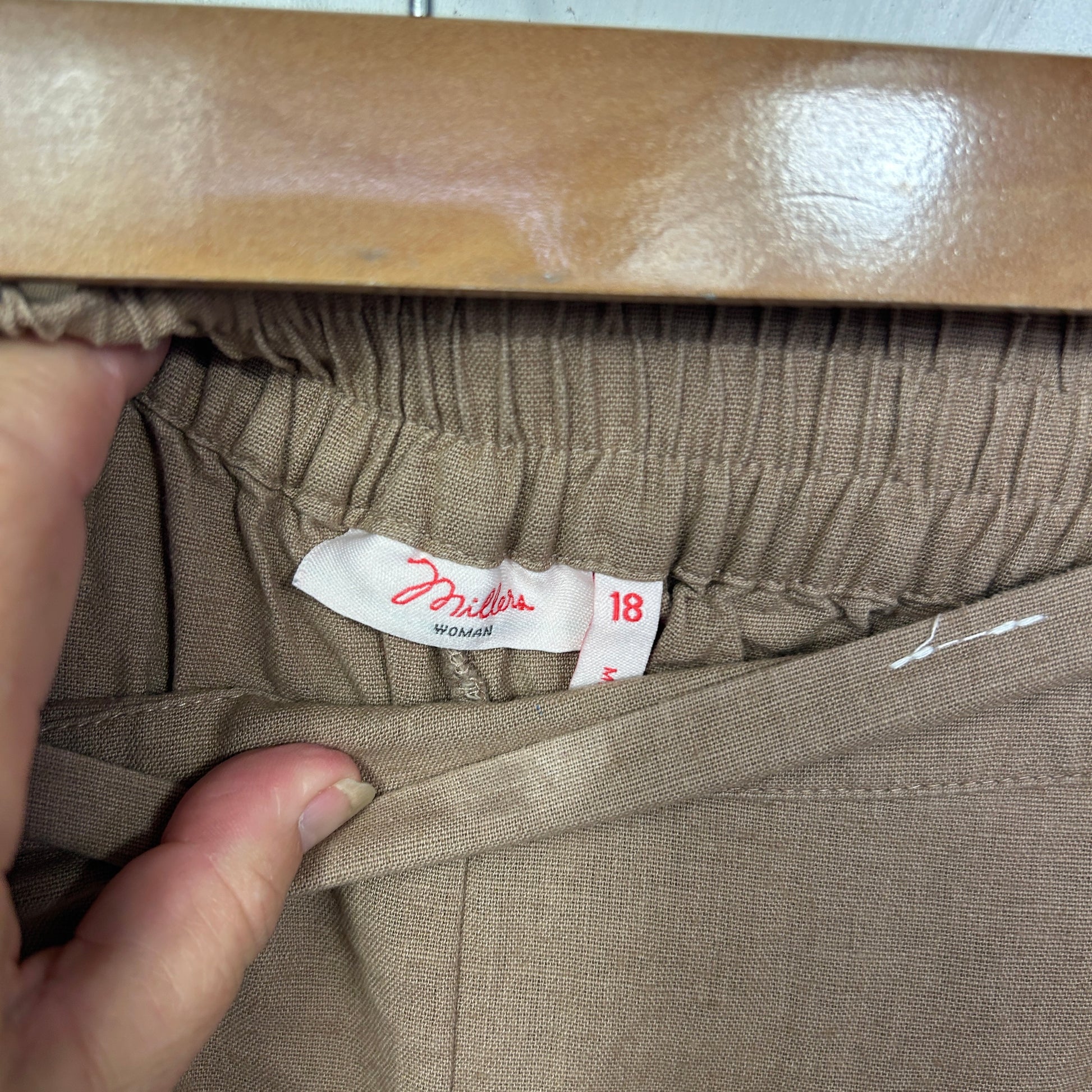 Beige pants label detail view