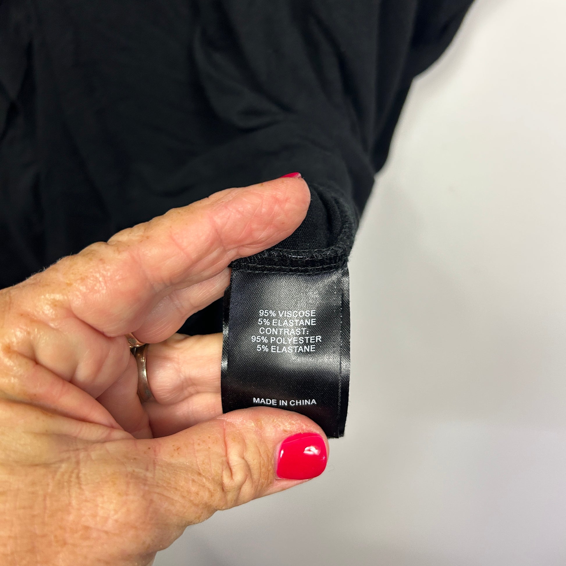 Black garment care label detail view