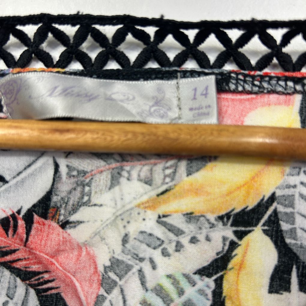 Floral fabric detail view with wooden rolling pin