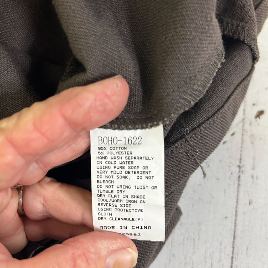 Grey knit sweater label detail view