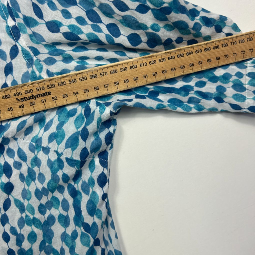 Blue and white patterned fabric detail view with measuring tape