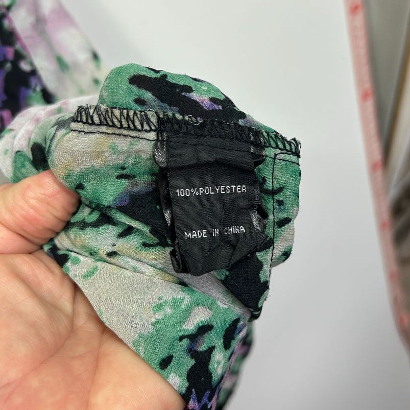 Green and black floral garment label detail view