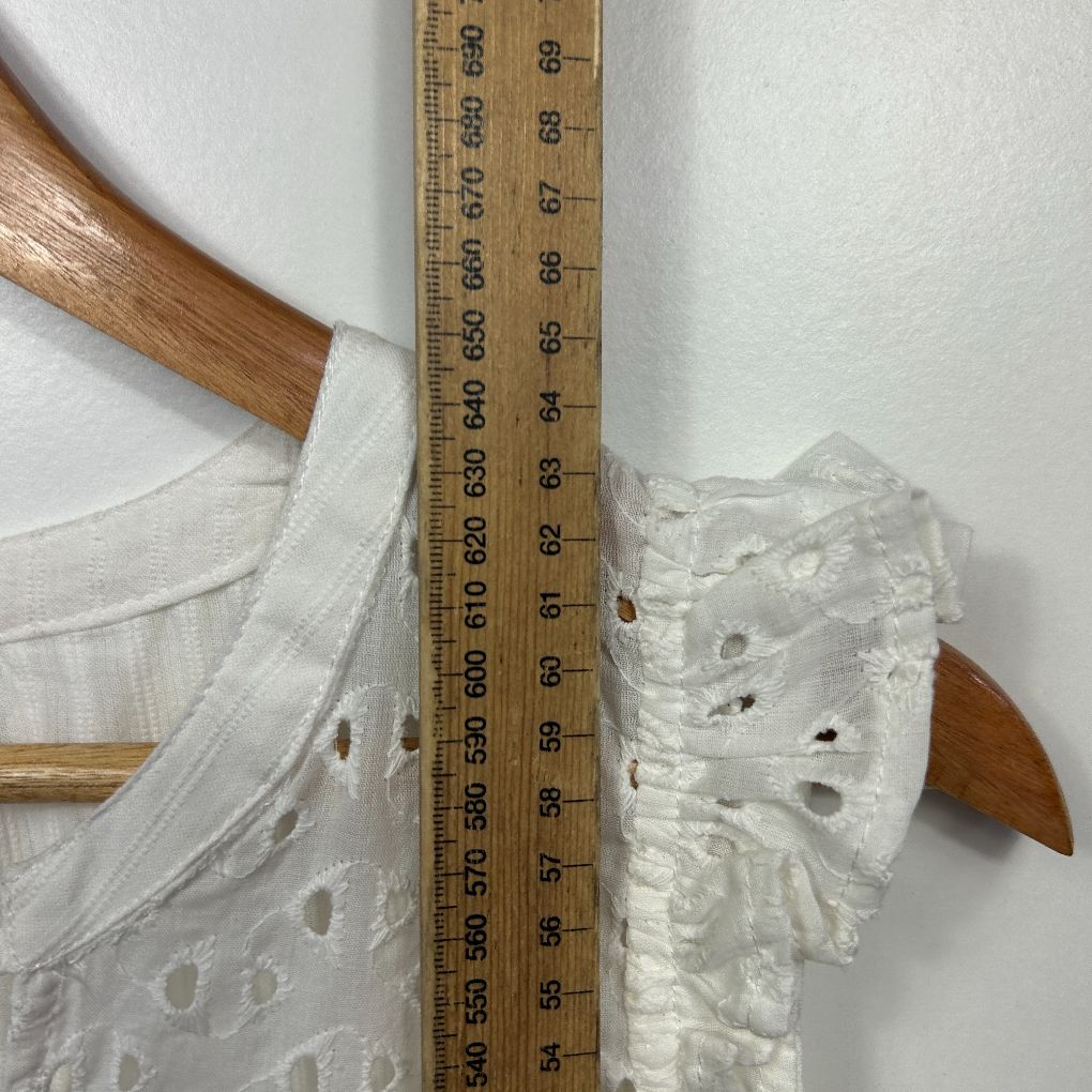 White textured blouse with wooden buttons detail view