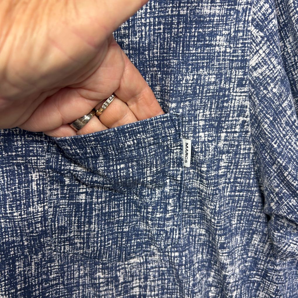 Navy blue textured shirt detail view showing fabric weave and button
