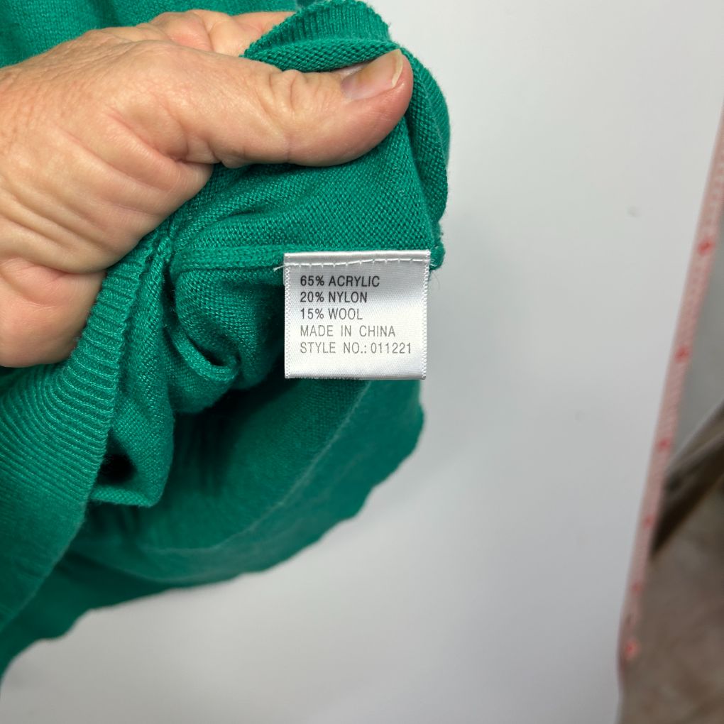 Green knit jumper label detail view