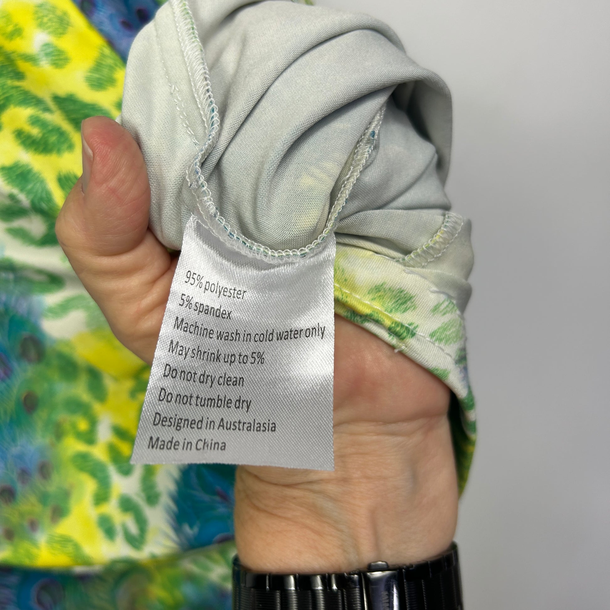 Yellow green floral garment label detail view