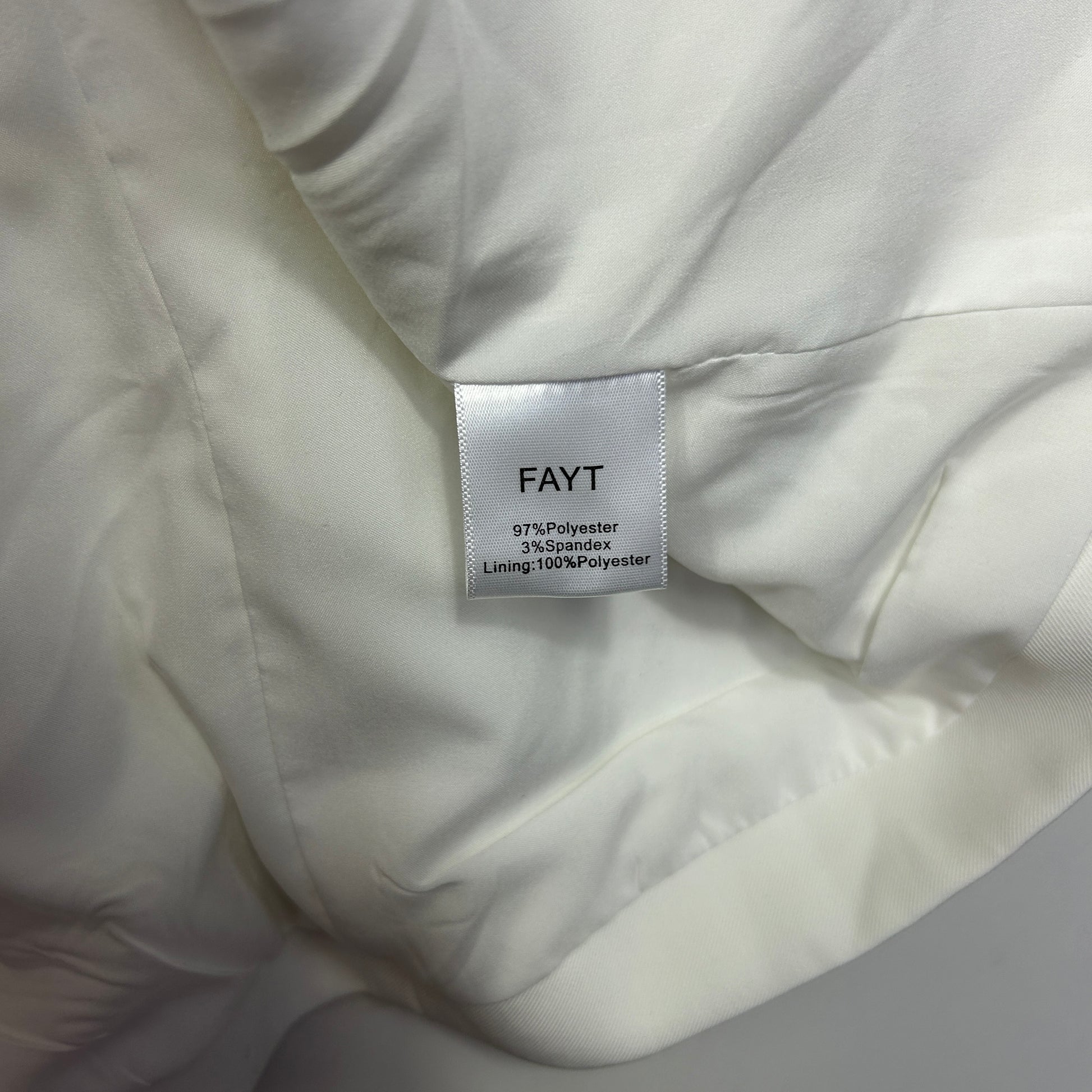 White puffer jacket label detail view