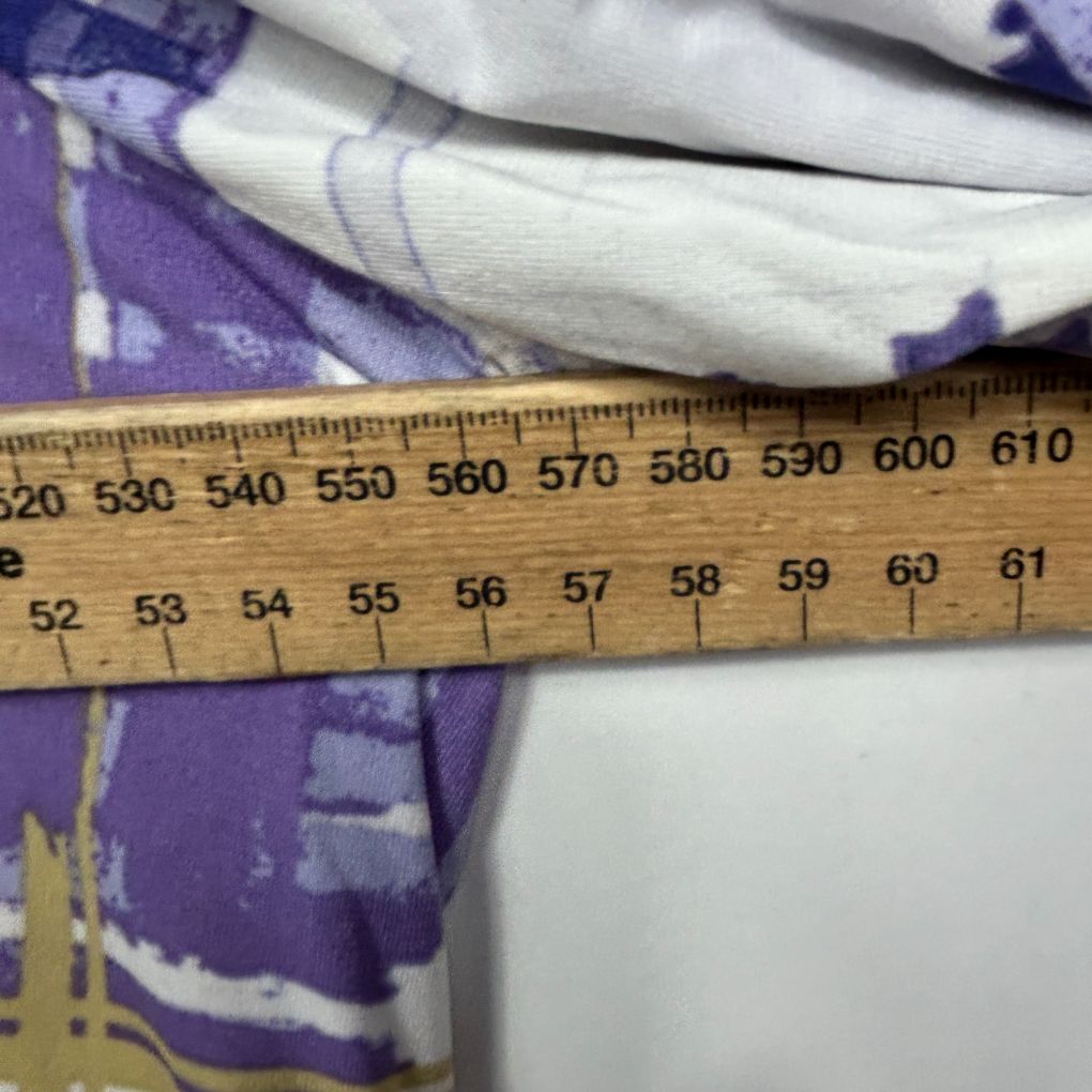 Purple and white patterned fabric with measurement ruler detail view