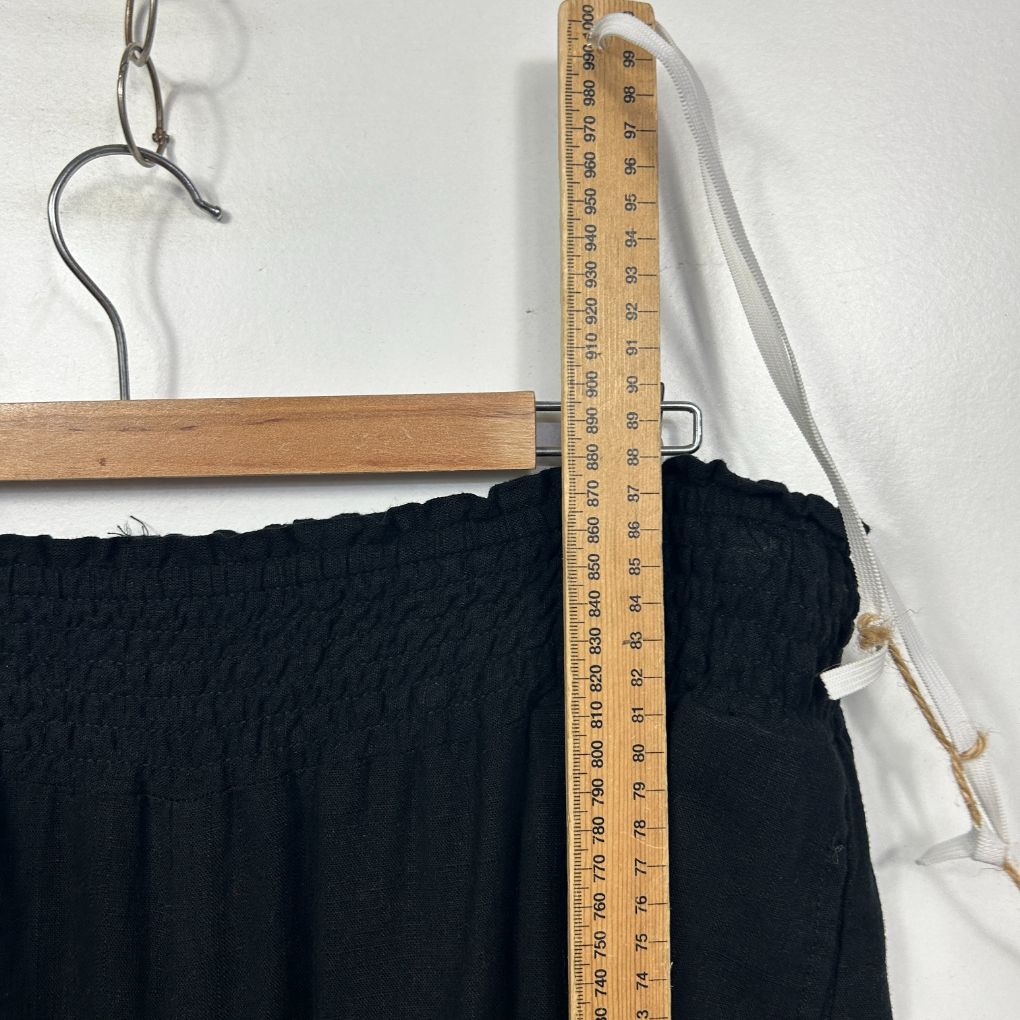 Black textured top with measuring tape detail view