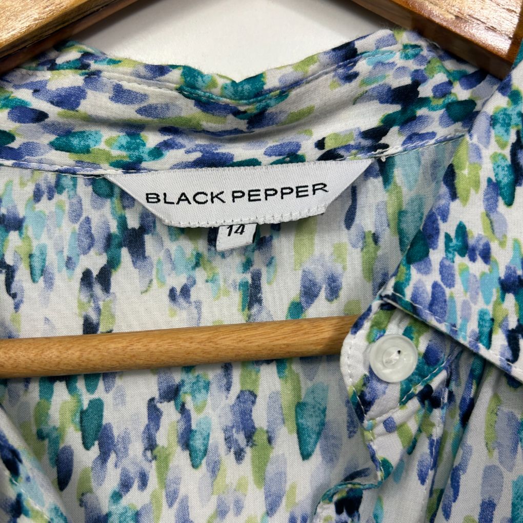 Blue green and white patterned shirt detail view showing Black Pepper label