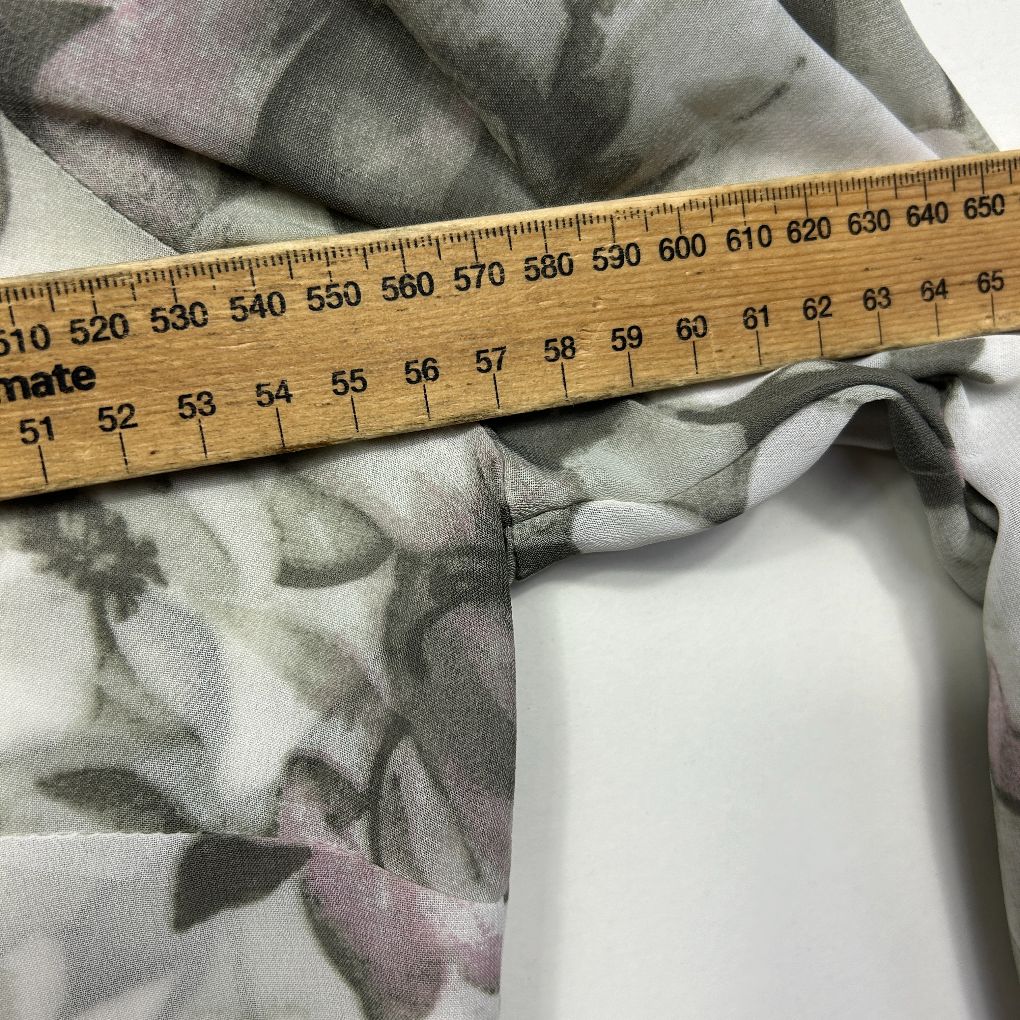 Grey floral scarf detail view with measuring tape
