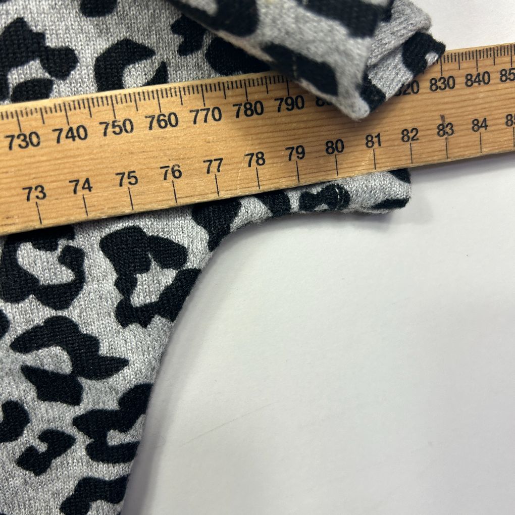 Black and white leopard print fabric detail view with measuring ruler