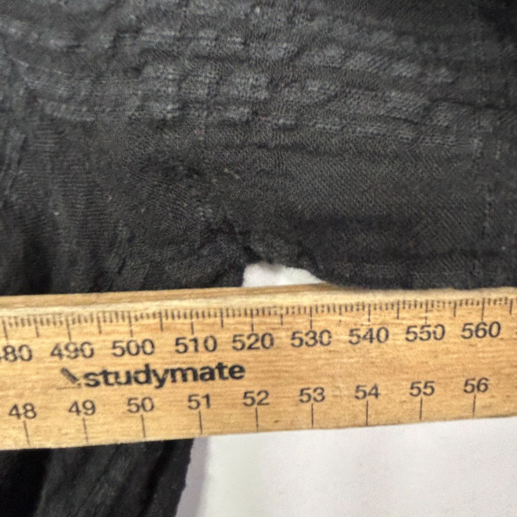 Black fabric detail view with measuring ruler
