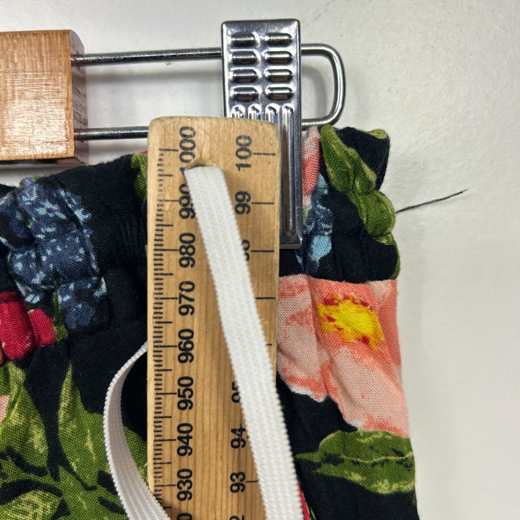 Floral clothing detail view with measuring tape