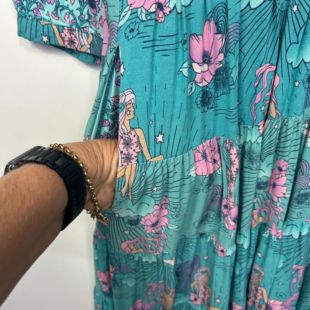 Turquoise floral dress detail view with pink flowers