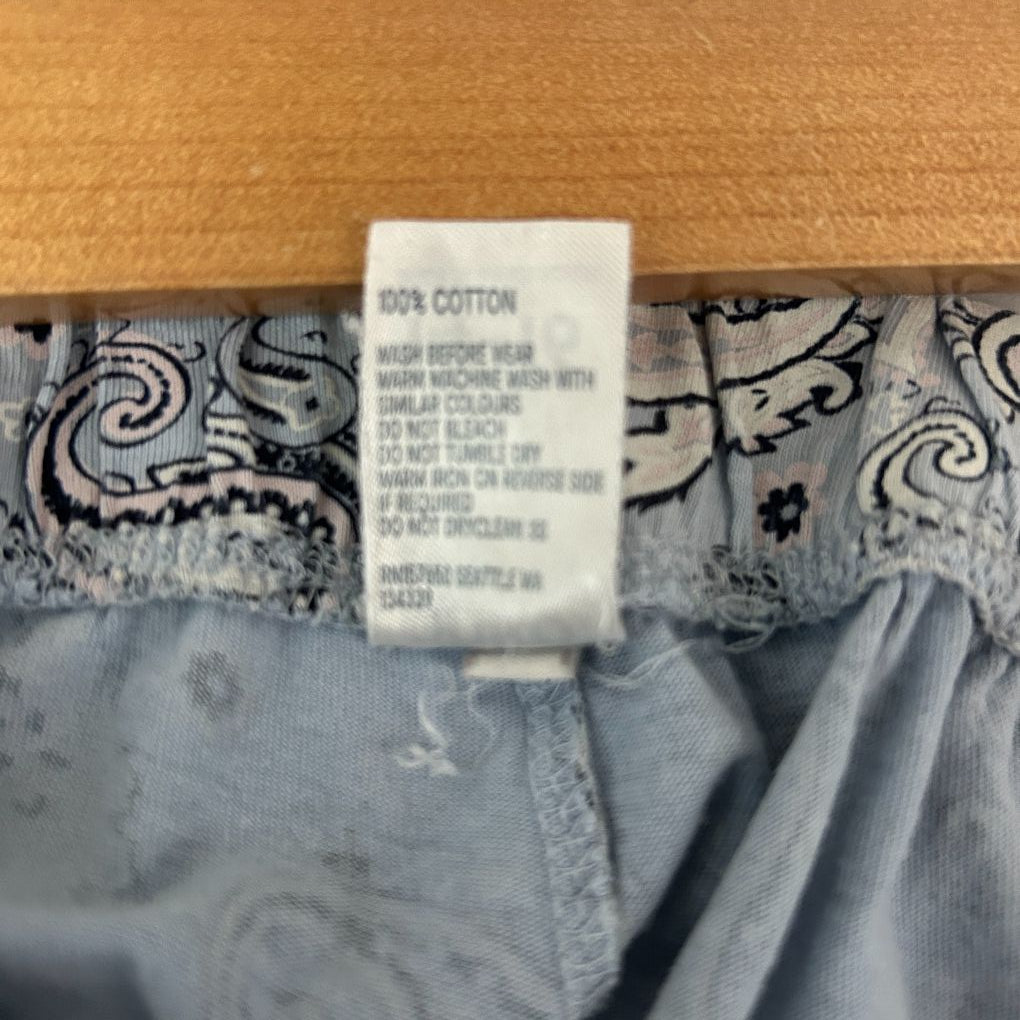Grey cardigan with ornate pattern detail view