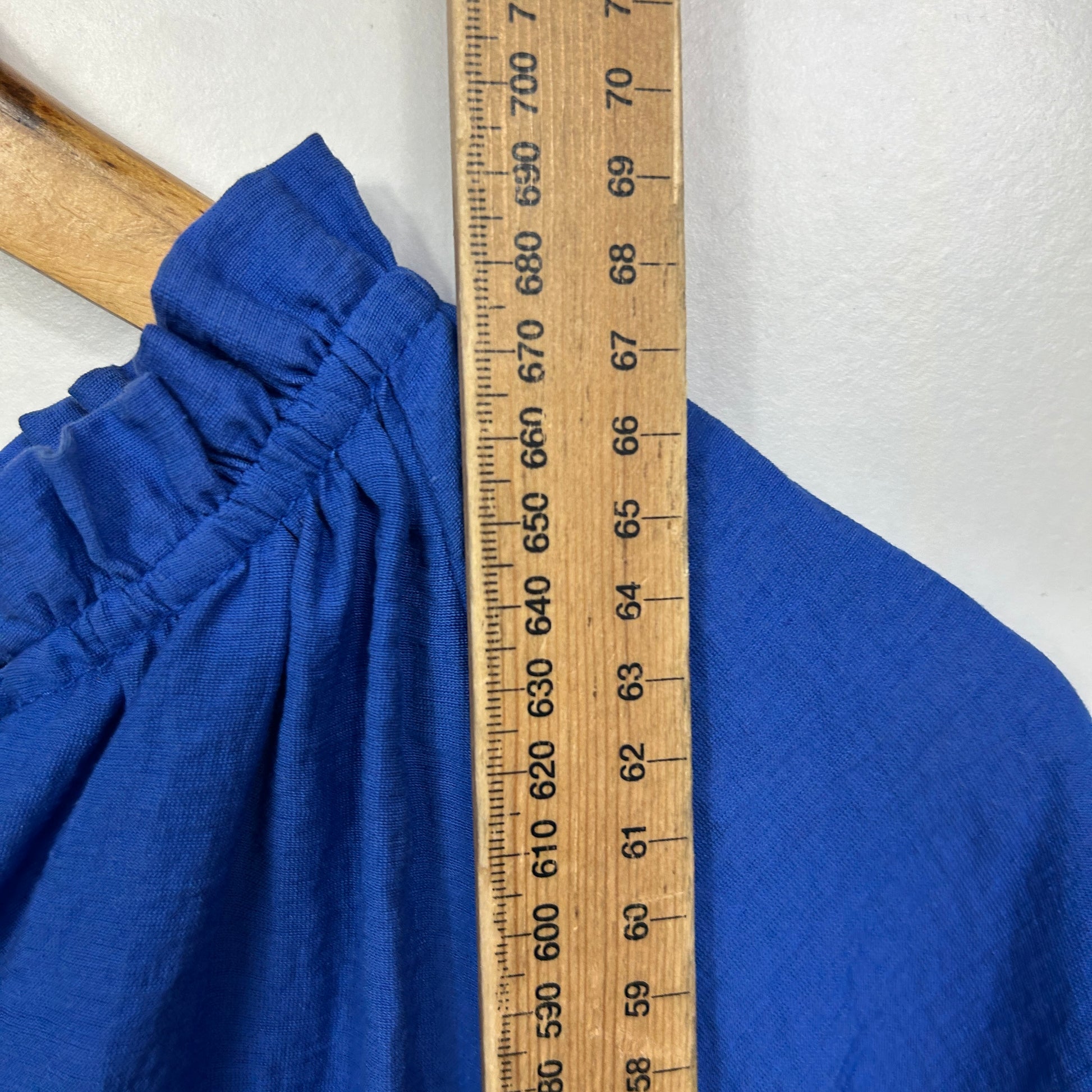 Blue top detail view with measuring tape