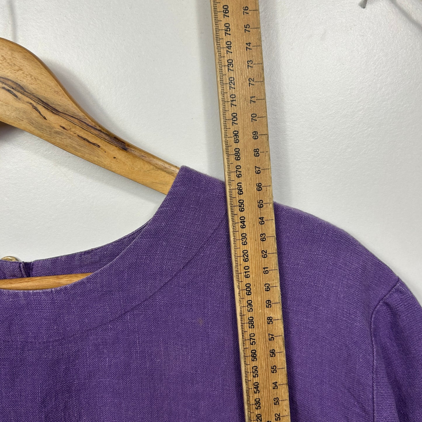 Purple long sleeve top front view with measuring tape