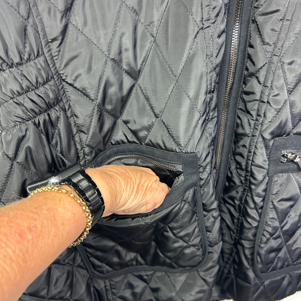 Grey quilted puffer jacket detail view showing pocket and zipper