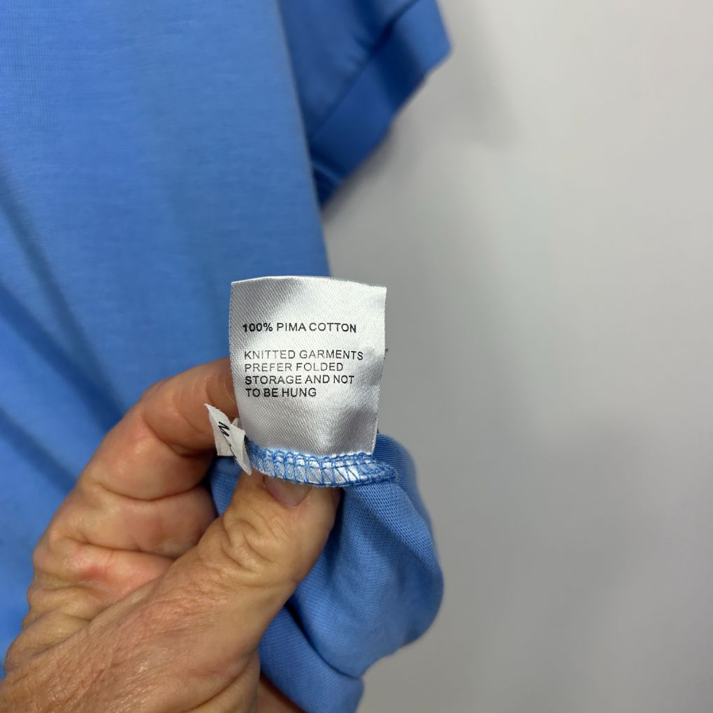 Blue cotton garment label detail view