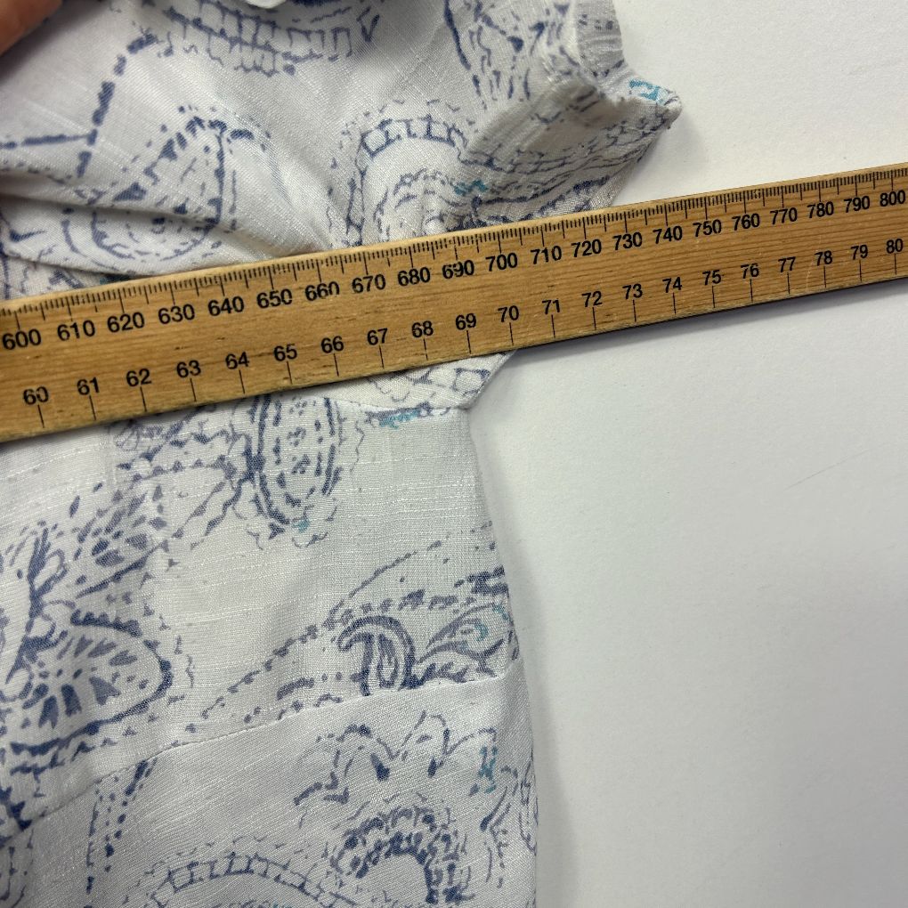 Blue and white patterned fabric with measuring tape detail view