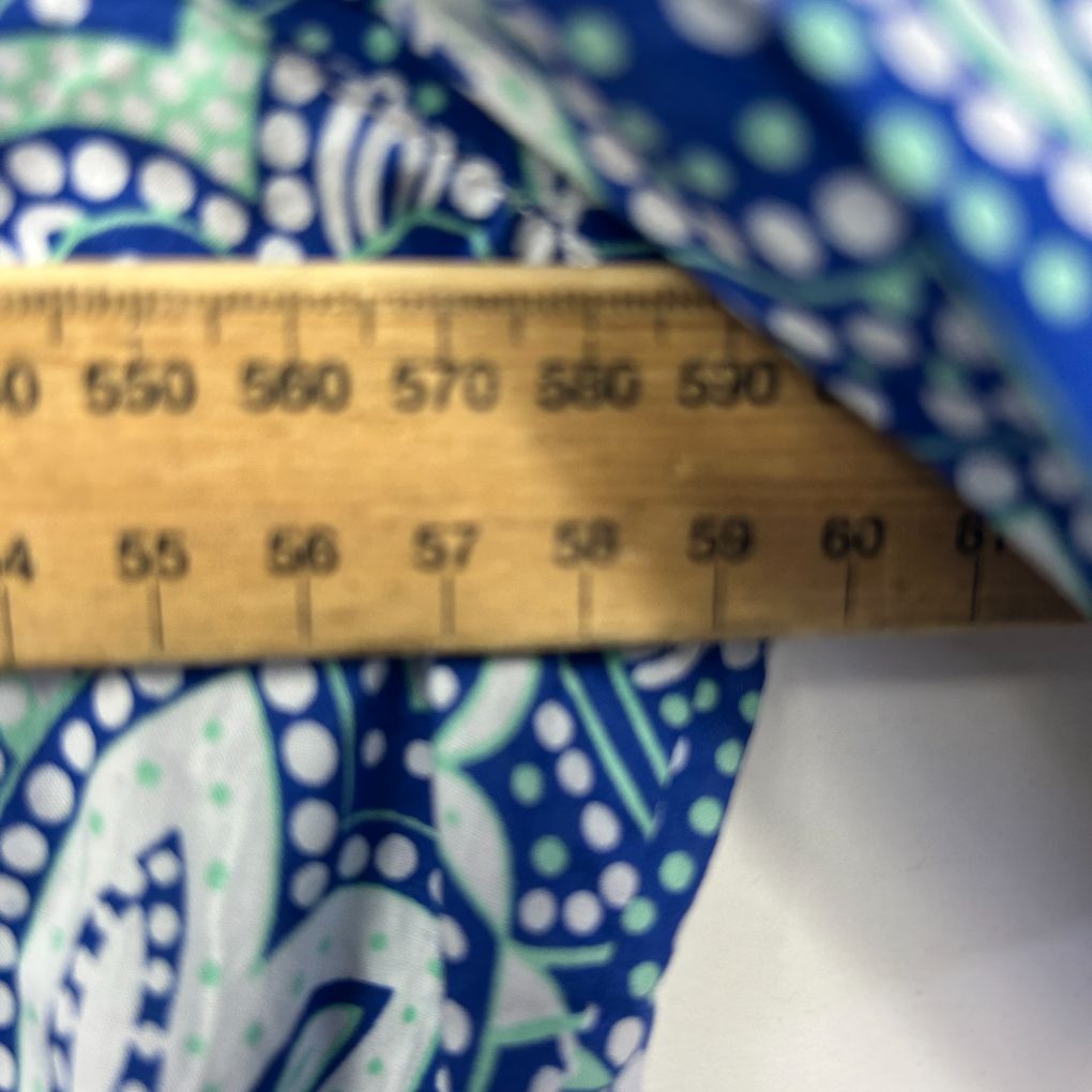 Blue patterned fabric detail view with measuring ruler