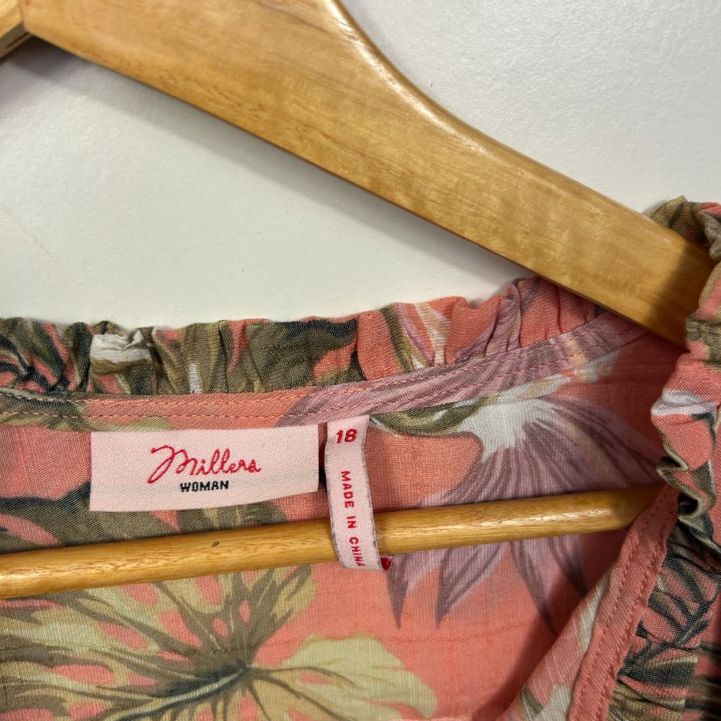 Pink floral top detail view with wooden hanger