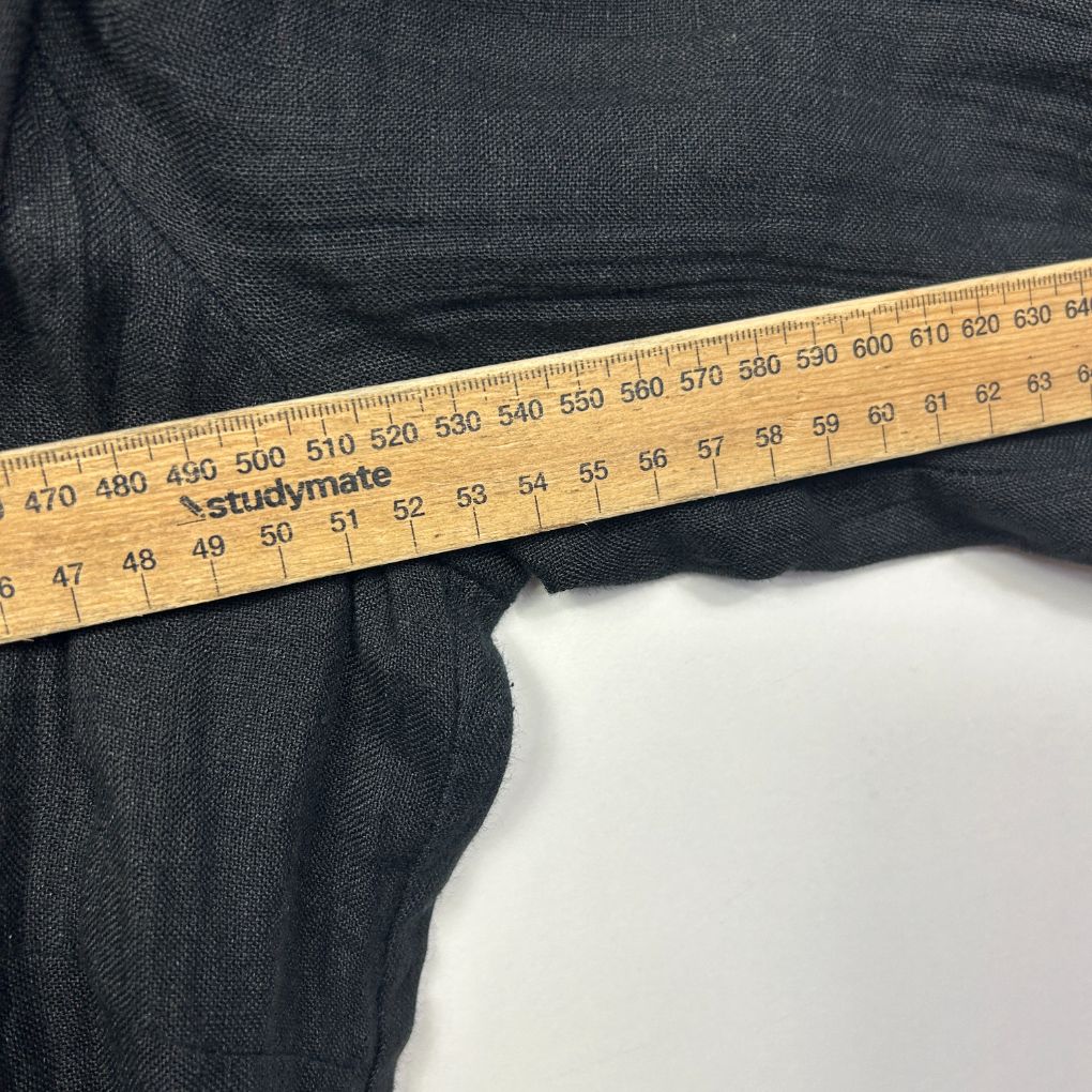 Dark navy denim jeans with measuring tape detail view