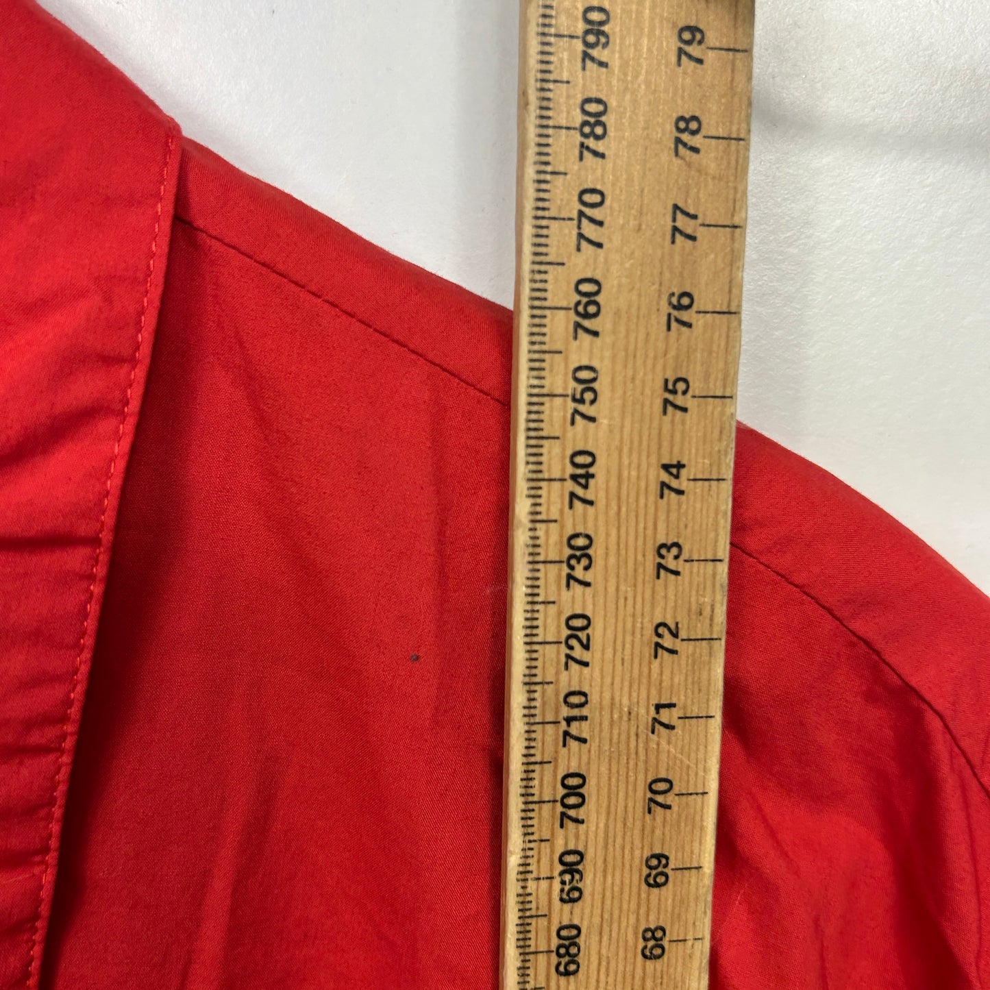 Red fabric with measurement ruler detail view