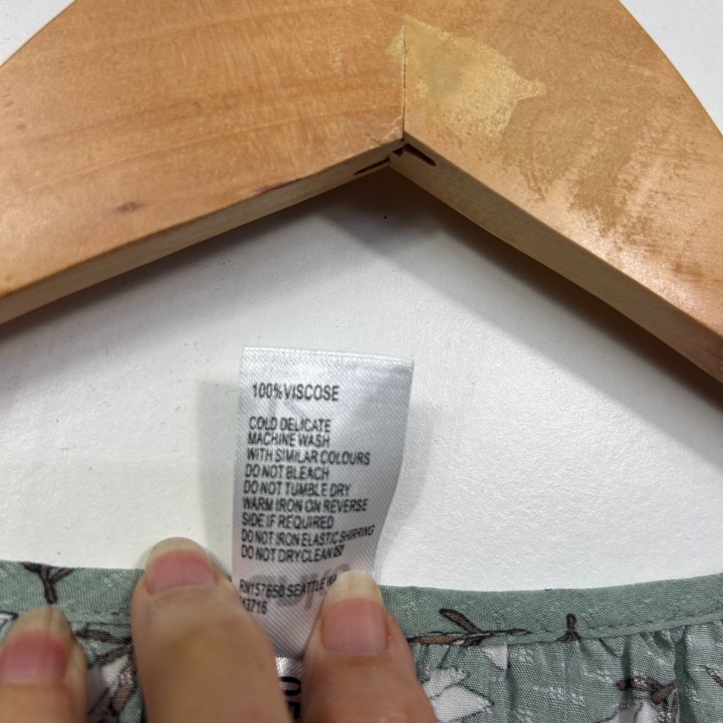 White garment care label detail view