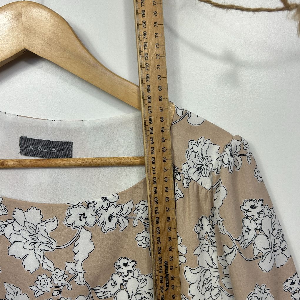 Beige floral top front view with measuring tape