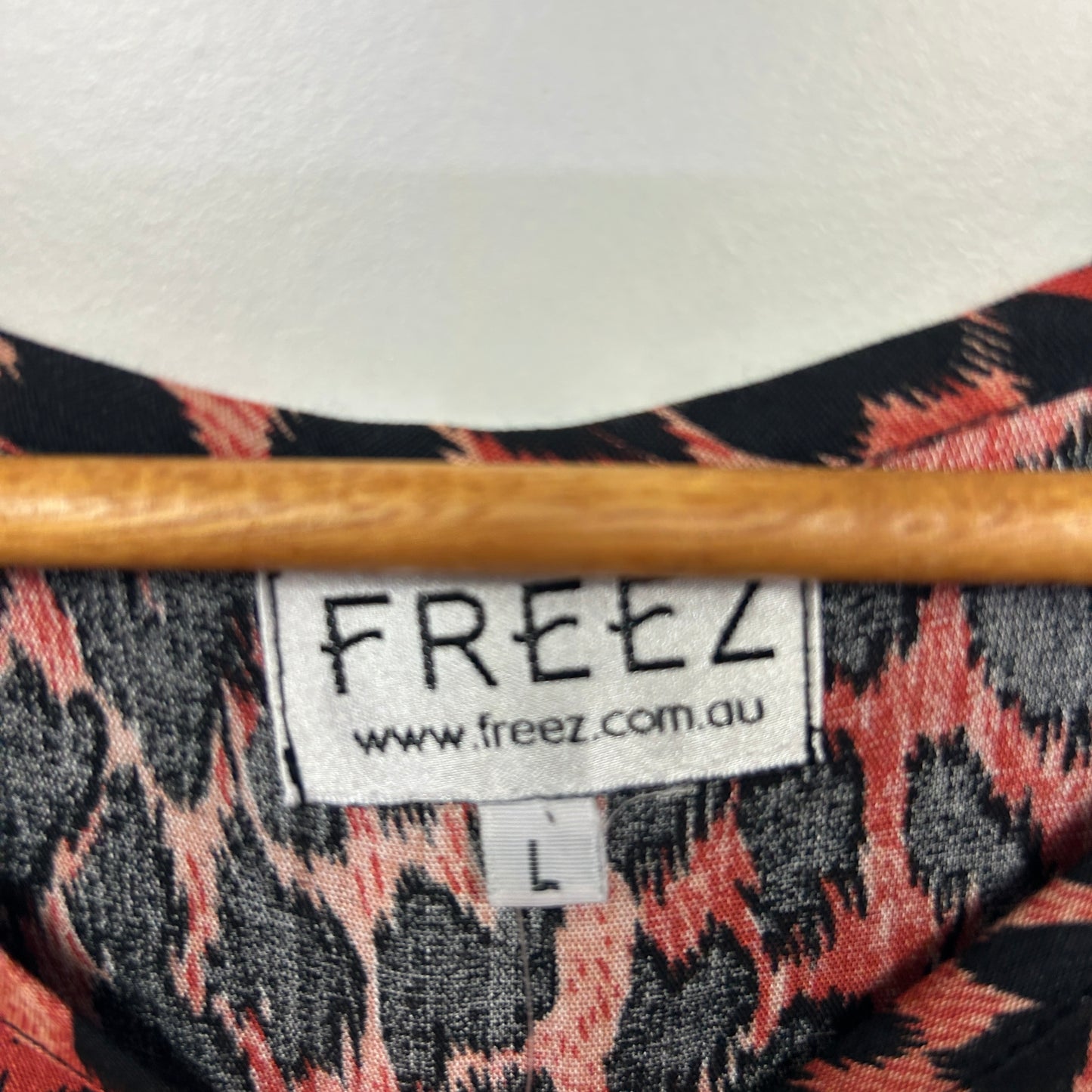 Freez brand label detail showing leopard print pattern in coral and black