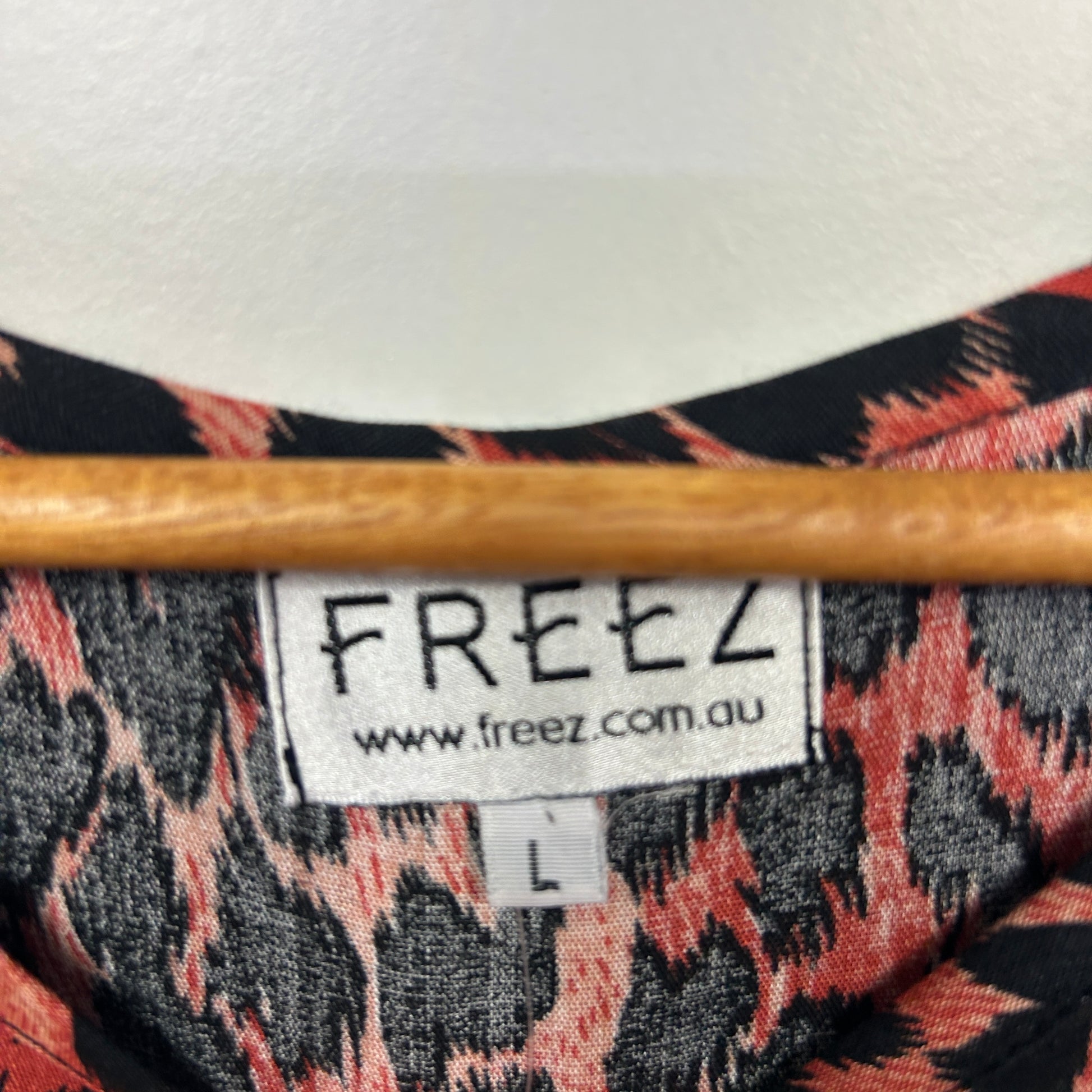 Freez brand label detail showing leopard print pattern in coral and black